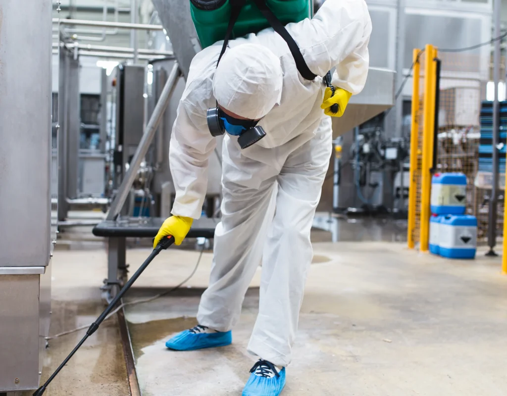 Pest control service technician providing pest control services for a industrial warehouse